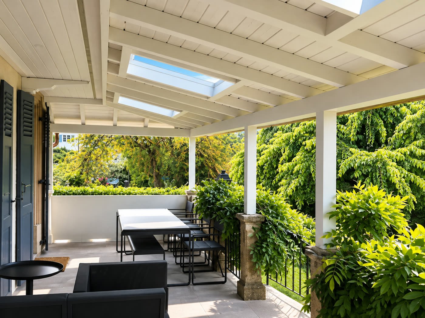 Terrasse couverte avec plafond en bois et fenêtres de toit